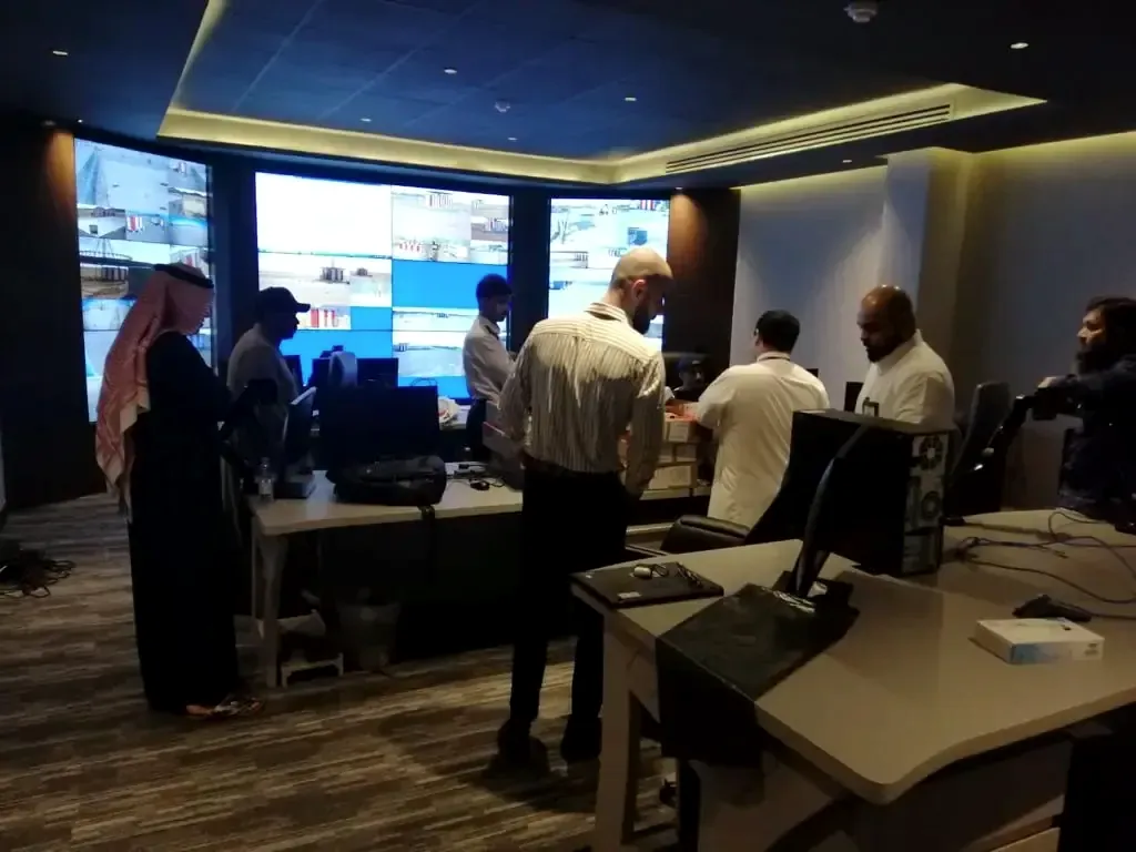 Operators in a monitoring room in front of a large video wall